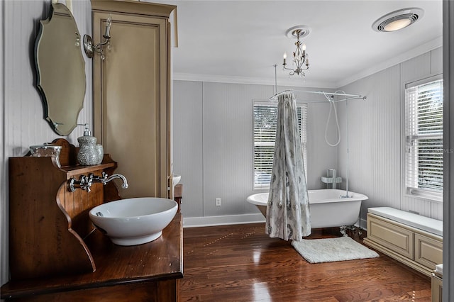 bathroom featuring hardwood / wood-style flooring, sink, ornamental molding, a chandelier, and shower with separate bathtub