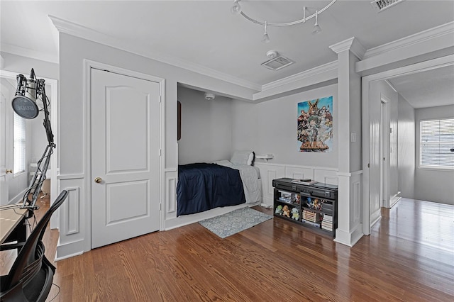 bedroom featuring ornamental molding and hardwood / wood-style floors