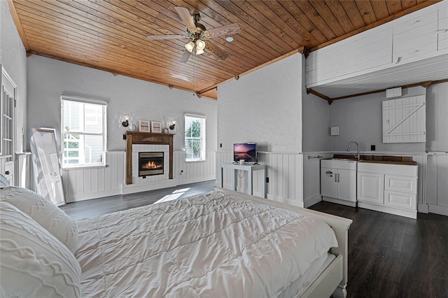 bedroom featuring dark wood-type flooring, ceiling fan, and wood ceiling