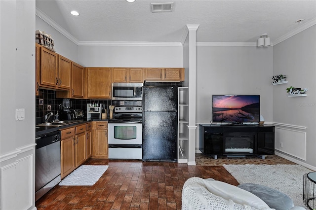 kitchen with stainless steel appliances, decorative backsplash, sink, ornamental molding, and dark hardwood / wood-style floors