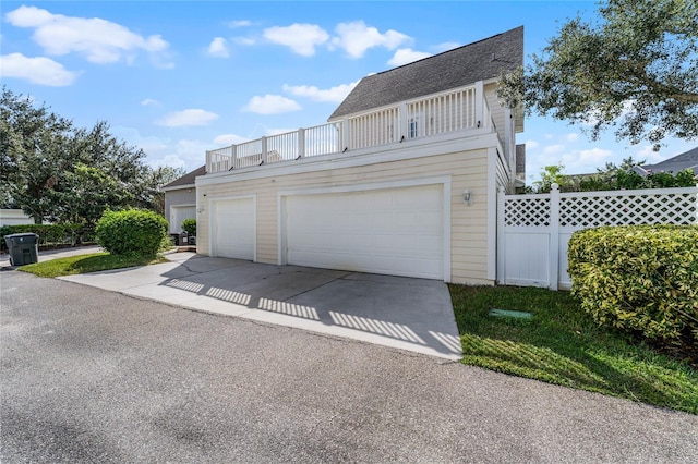 exterior space with a balcony and a garage