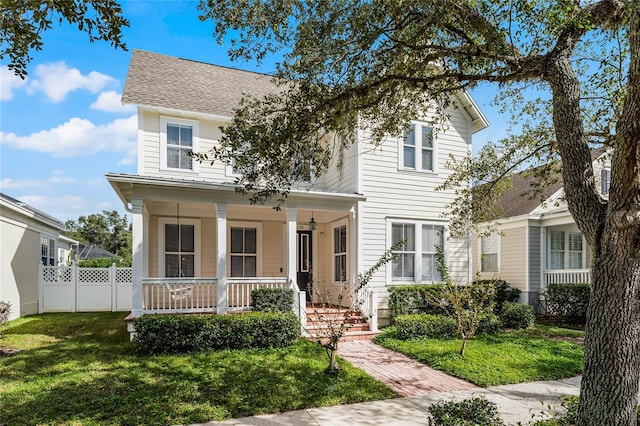 view of front of home featuring a front yard and covered porch