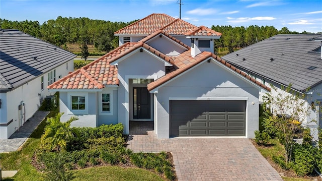 mediterranean / spanish home with a garage