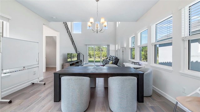 dining room featuring light hardwood / wood-style floors and a notable chandelier