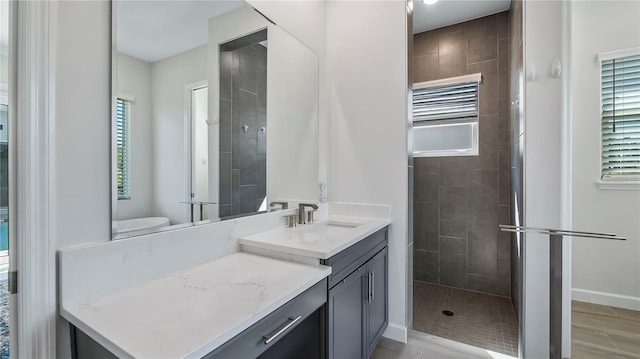 bathroom featuring vanity and tiled shower