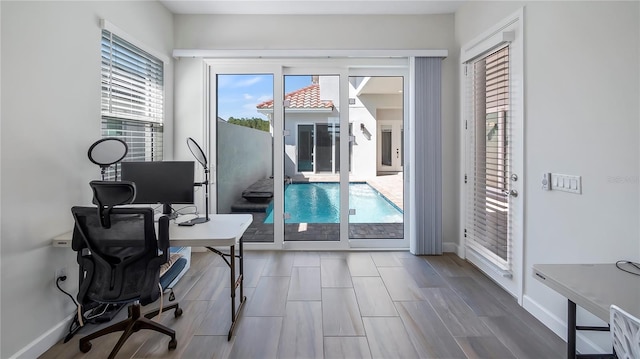 office space with hardwood / wood-style flooring and a healthy amount of sunlight