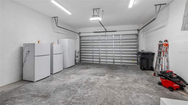 garage with white refrigerator and a garage door opener