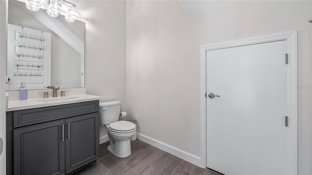 bathroom with toilet and vanity