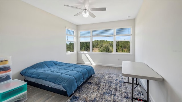 bedroom with hardwood / wood-style floors and ceiling fan