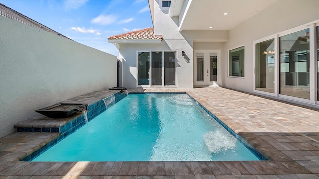 view of pool with pool water feature and a patio area