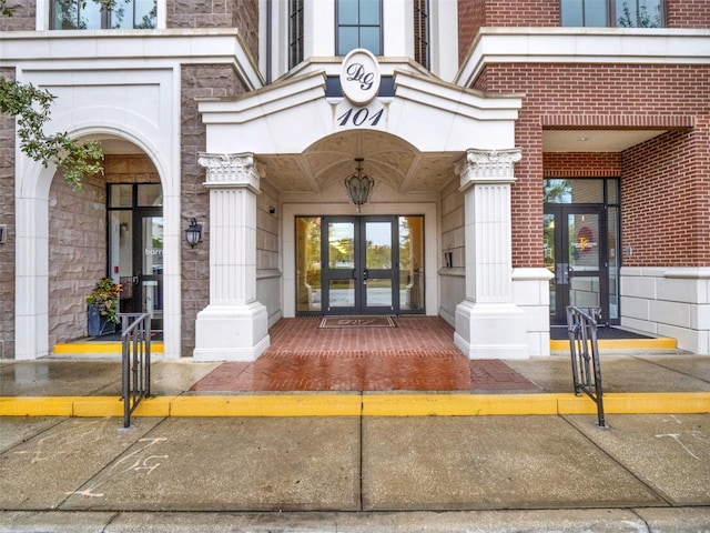 property entrance with brick siding and french doors