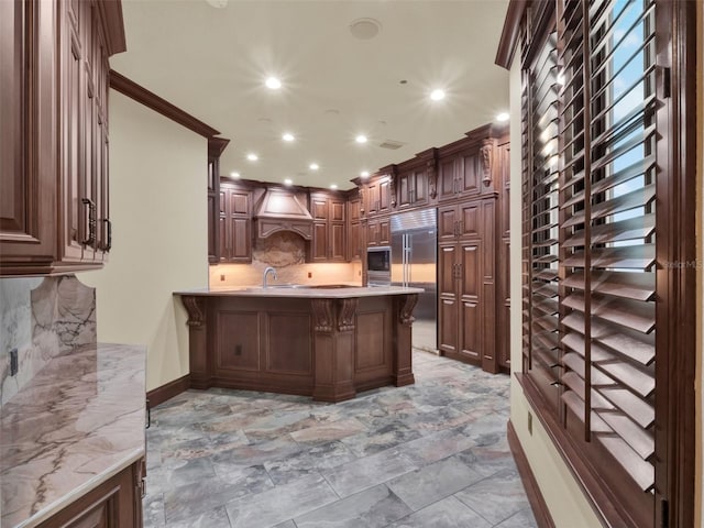 kitchen with tasteful backsplash, built in appliances, a breakfast bar, recessed lighting, and a peninsula