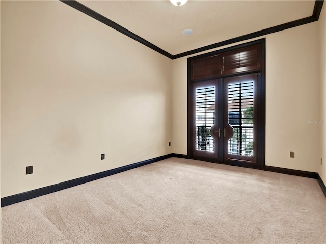 unfurnished room with light colored carpet, baseboards, french doors, and ornamental molding