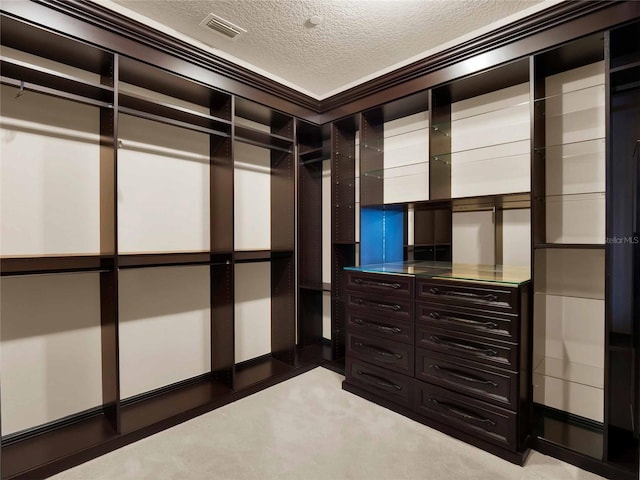 walk in closet with light carpet and visible vents