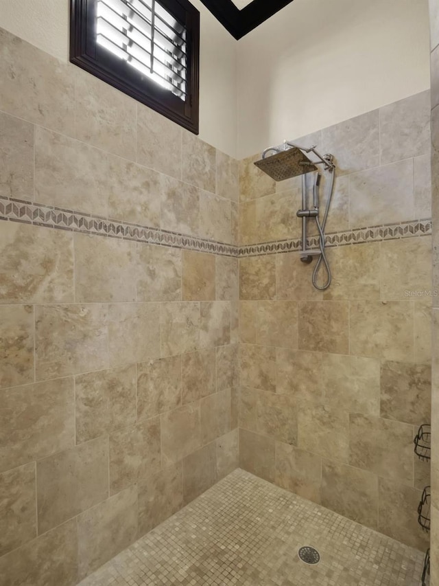 full bath featuring a tile shower