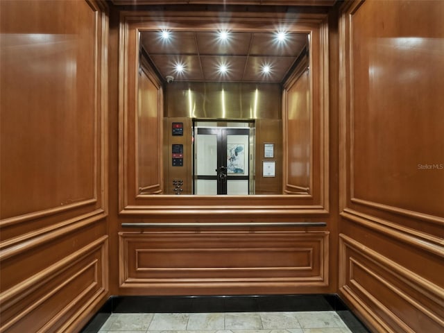 interior details featuring elevator and french doors