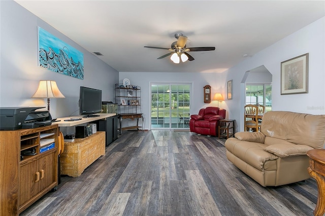 living room with dark hardwood / wood-style floors and ceiling fan