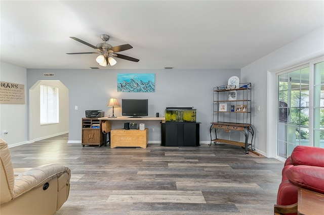 living room featuring wood-type flooring and ceiling fan