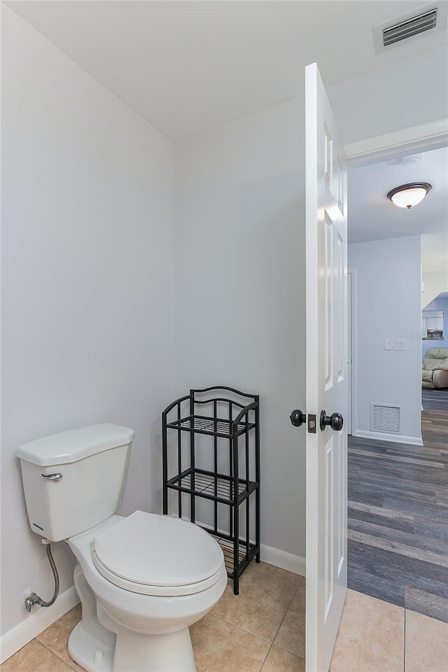 bathroom featuring hardwood / wood-style flooring and toilet