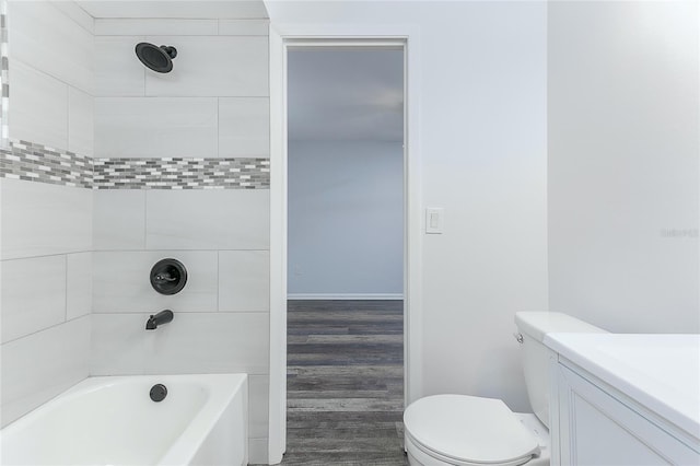 full bathroom featuring tiled shower / bath, hardwood / wood-style floors, vanity, and toilet