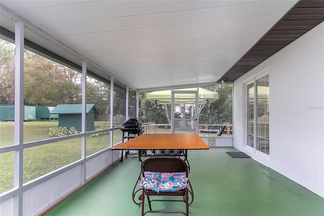 sunroom / solarium featuring lofted ceiling and a wealth of natural light