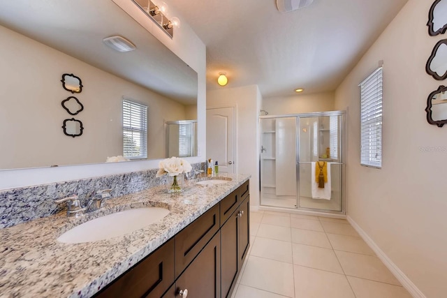 bathroom with tile patterned flooring, vanity, and a shower with door