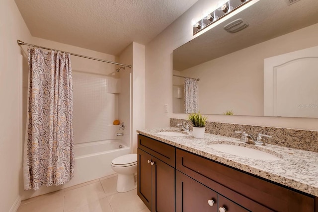 full bathroom featuring a textured ceiling, shower / bath combo with shower curtain, vanity, tile patterned floors, and toilet