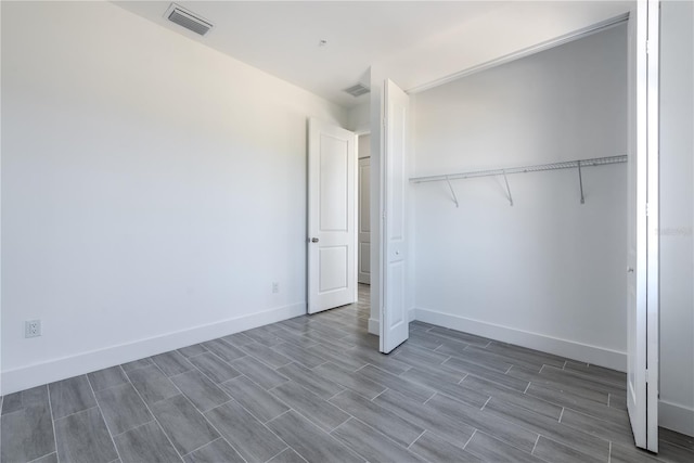 unfurnished bedroom with hardwood / wood-style flooring and a closet