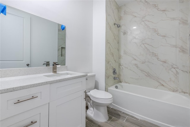 full bathroom with toilet, tiled shower / bath combo, and vanity