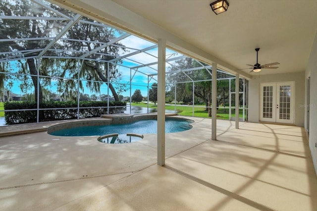 view of swimming pool with a hot tub, a patio area, a lanai, and ceiling fan