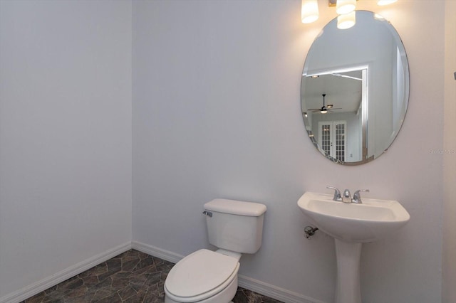 bathroom with sink, toilet, and ceiling fan