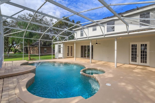 view of swimming pool with ceiling fan, glass enclosure, french doors, and a patio area