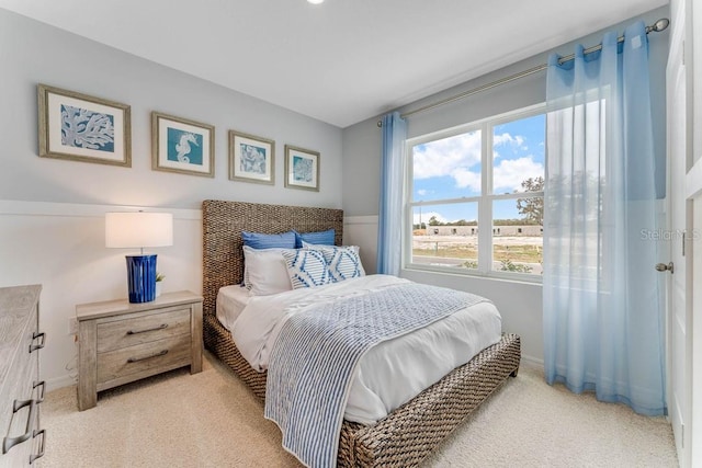 bedroom featuring light colored carpet