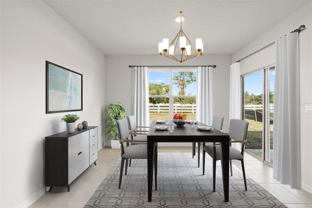 dining space featuring light tile patterned floors, a healthy amount of sunlight, and a notable chandelier