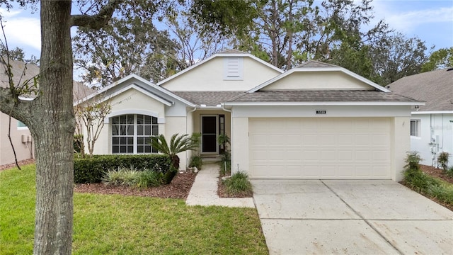 ranch-style home with a garage and a front lawn