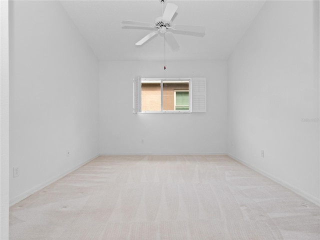 spare room featuring light colored carpet and ceiling fan