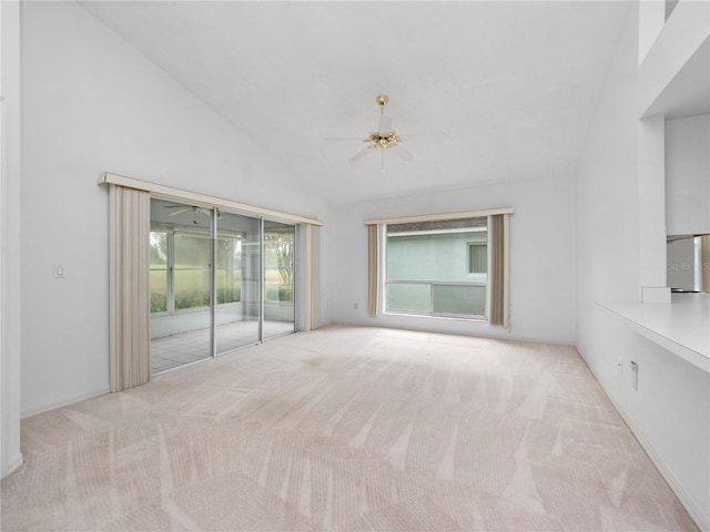 unfurnished room with ceiling fan, light carpet, and high vaulted ceiling