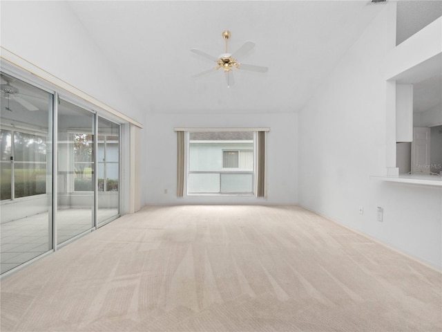 unfurnished living room featuring light colored carpet, ceiling fan, and vaulted ceiling