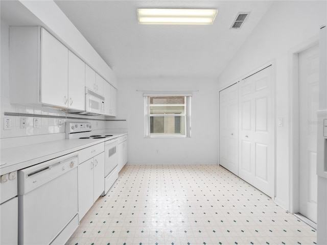 kitchen featuring white cabinets, white appliances, and vaulted ceiling