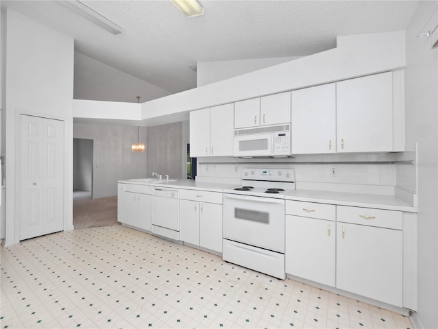 kitchen with white cabinetry, a textured ceiling, high vaulted ceiling, pendant lighting, and white appliances