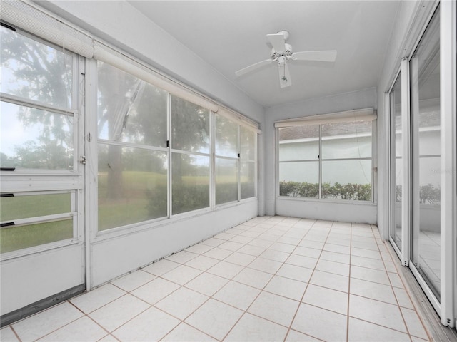 unfurnished sunroom featuring ceiling fan