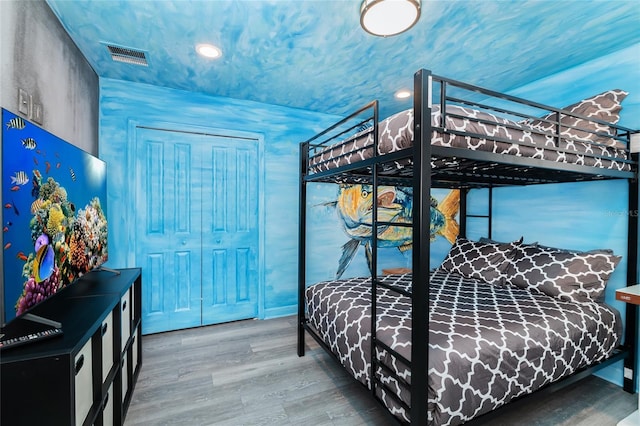 bedroom featuring hardwood / wood-style floors and a closet