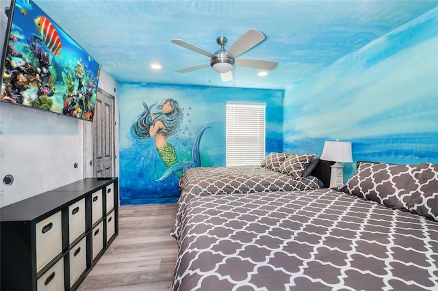 bedroom with ceiling fan and light hardwood / wood-style floors