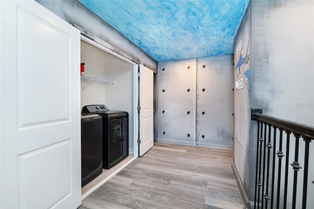 washroom featuring independent washer and dryer and light wood-type flooring