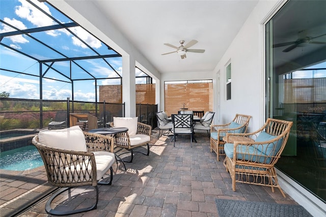 view of patio / terrace with ceiling fan, a lanai, and a pool with hot tub