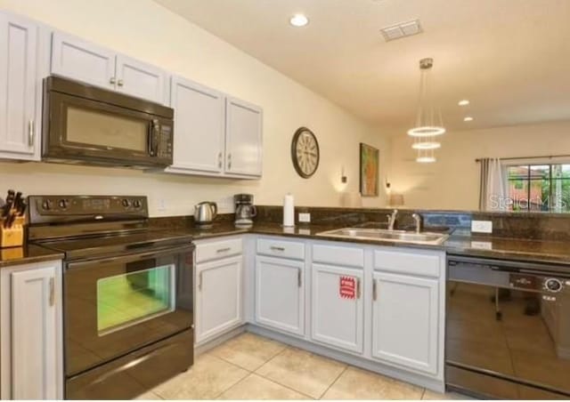 kitchen with black appliances, white cabinetry, light tile patterned floors, hanging light fixtures, and sink