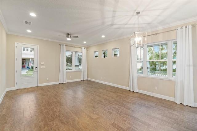 unfurnished room featuring visible vents, wood finished floors, recessed lighting, crown molding, and baseboards