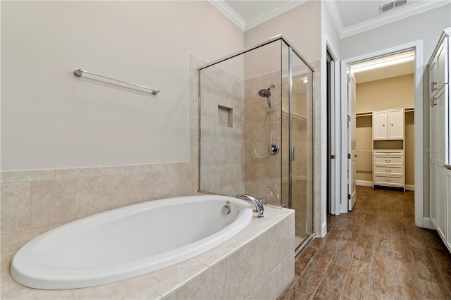 bathroom with crown molding, hardwood / wood-style floors, and independent shower and bath