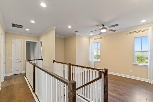 corridor featuring ornamental molding and dark wood-type flooring