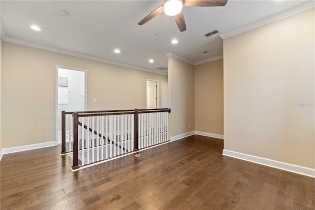 unfurnished room with ceiling fan, crown molding, and dark wood-type flooring